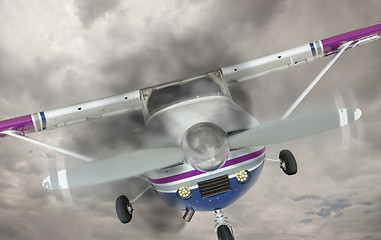 Image showing Cessna 172 With Smoke Coming From Engine Against Gray Sky