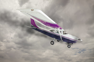 Image showing Cessna 172 With Smoke Coming From Engine Against Gray Sky