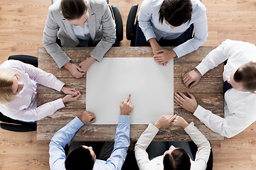Image showing close up of business team with paper at table