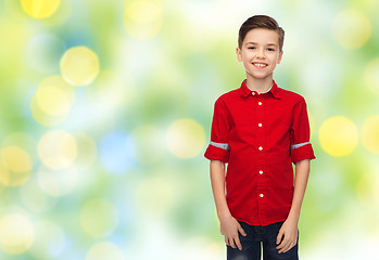 Image showing happy boy in red shirt over green lights