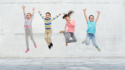 Image showing happy little girl jumping in air on street