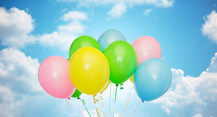 Image showing bunch of inflated helium balloons over blue sky