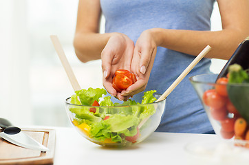 Image showing close up of woman cooking vegetable salad at home