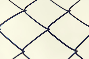 Image showing close up of mesh fence over gray sky