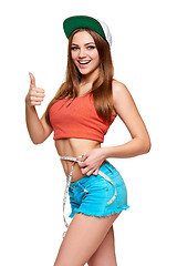 Image showing Excited teen girl measuring her waist 