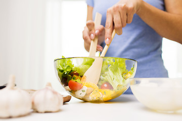 Image showing close up of woman cooking vegetable salad at home