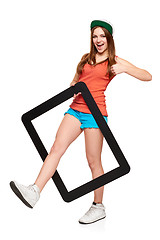 Image showing Teen funky girl standing with a frame