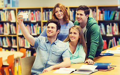 Image showing students with smartphone taking selfie in library