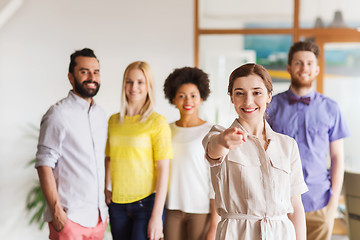 Image showing woman pointing to you over creative office team