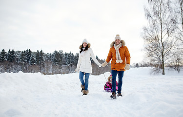 Image showing happy family with sled walking in winter outdoors