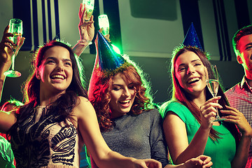 Image showing smiling friends with glasses of champagne in club