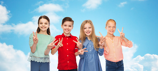 Image showing happy boy and girls showing peace hand sign