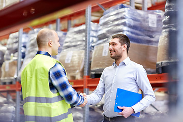 Image showing worker and businessmen with clipboard at warehouse