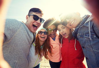 Image showing happy laughing friends taking selfie