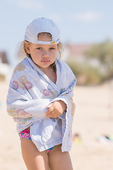 Image showing Frozen four-year girl standing on the sandy beach sea