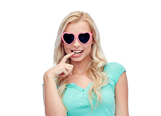 Image showing happy young woman in heart shape sunglasses