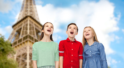 Image showing amazed children looking up over eiffel tower