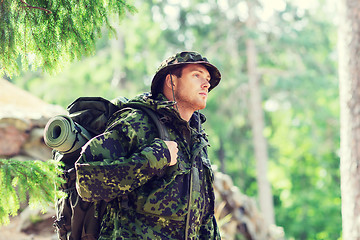 Image showing young soldier with backpack in forest