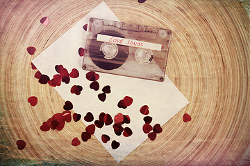 Image showing Audio cassette tape on red backgound with fabric heart