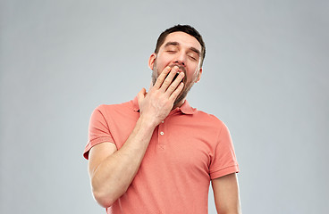 Image showing yawning man over gray background