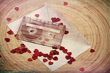 Image showing Audio cassette tape on red backgound with fabric heart