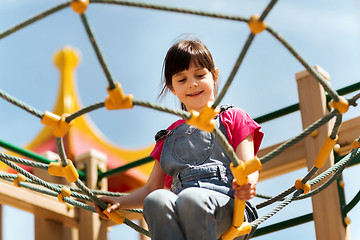 Image showing happy little girl climbing on children playground