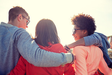 Image showing happy teenage friends in shades hugging on street