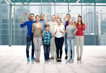 Image showing group of smiling people showing thumbs up