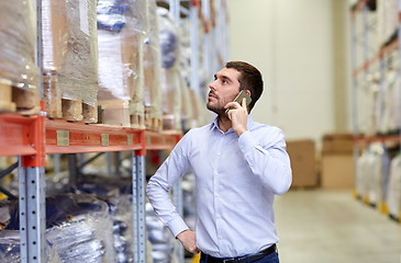 Image showing serious man calling on smartphone at warehouse