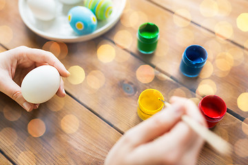 Image showing close up of woman hands coloring easter eggs