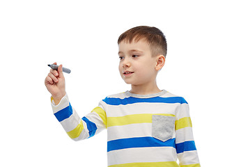 Image showing little boy drawing or writing with marker