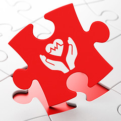 Image showing Insurance concept: Heart And Palm on puzzle background