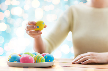 Image showing close up of woman hands with colored easter eggs