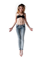 Image showing Beautiful flying girl in jeans and bra