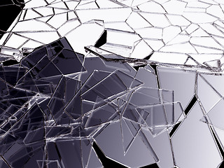 Image showing Pieces of splitted or cracked glass on black