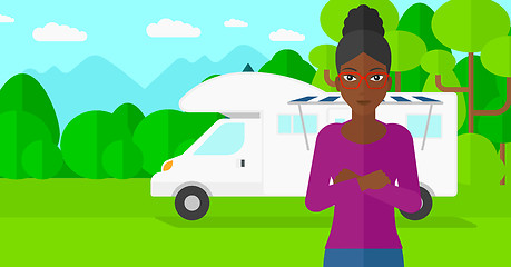 Image showing Woman standing in front of motor home.