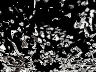 Image showing Pieces of splitted or cracked glass isolated on black