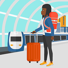 Image showing Woman with suitcase on wheels and briefcase.