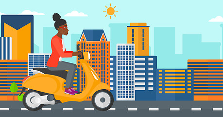 Image showing Woman riding scooter.