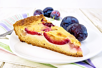 Image showing Pie plum with sour cream in plate on light board