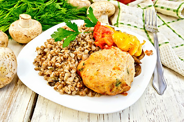 Image showing Cutlets of turkey with buckwheat in plate on board