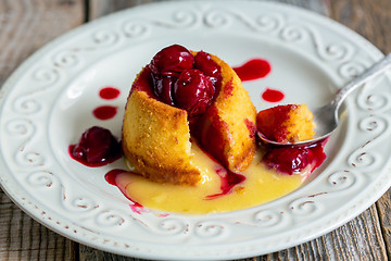 Image showing Dessert White chocolate with cherry sauce.