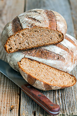 Image showing Fresh homemade bread and knife.