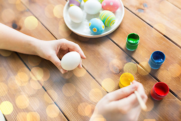 Image showing close up of woman hands coloring easter eggs