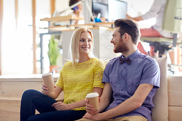 Image showing happy man and woman drinking coffee in office