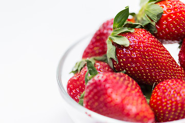 Image showing close up of ripe red strawberries over white
