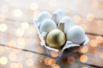 Image showing close up of white and gold eggs in egg box