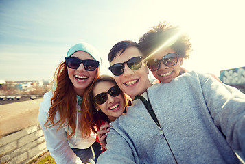 Image showing group of happy friends taking selfie on street