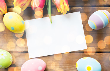 Image showing close up of easter eggs, flowers and white paper