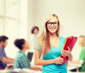 Image showing smiling student with folders in eyeglasses